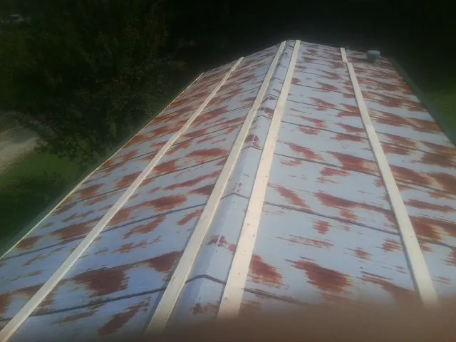 Rusted metal roof panels with new wood purlins before replacement — Storm Damage Roof Repair in Brian Head by Roofing Brothers